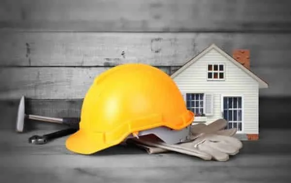 repair tools and helmet in front of the model home