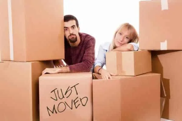tired couple on moving boxes