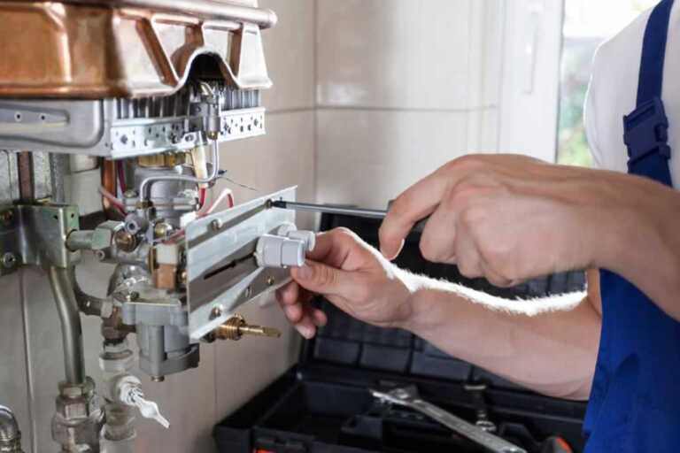 technician fixing a gas furnace