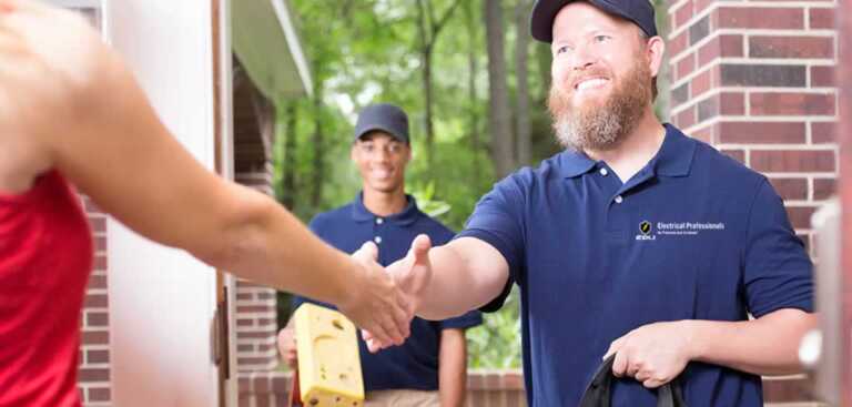 electrician shaking hand with homeowner