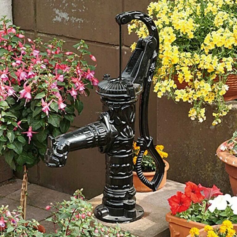 decorated rustic well pump in the backyard