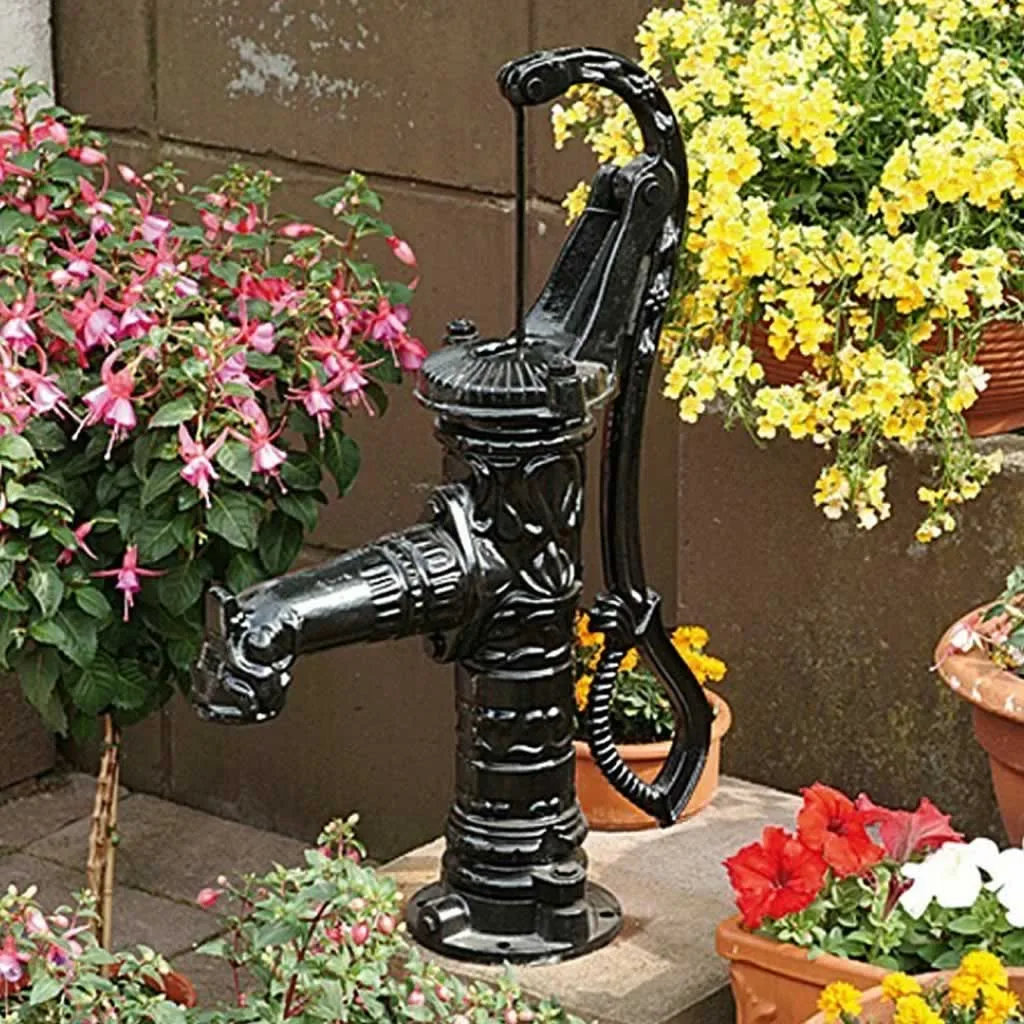 decorated rustic well pump in the backyard