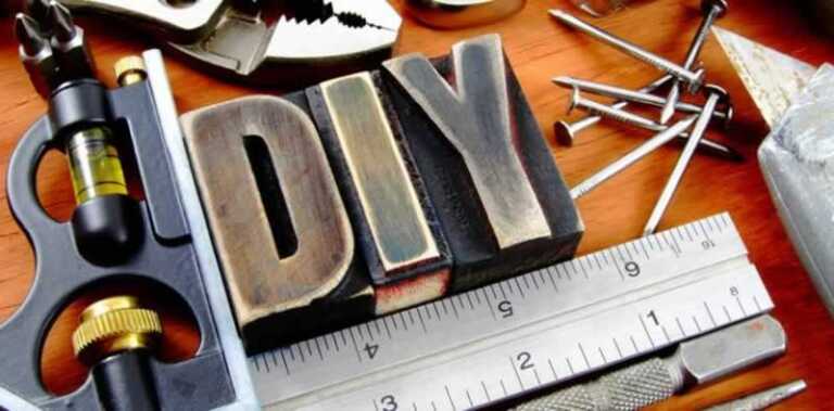 various tools on the table along with metal DIY sign