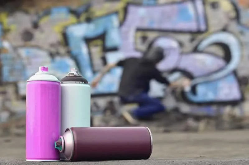 three spray paint cans