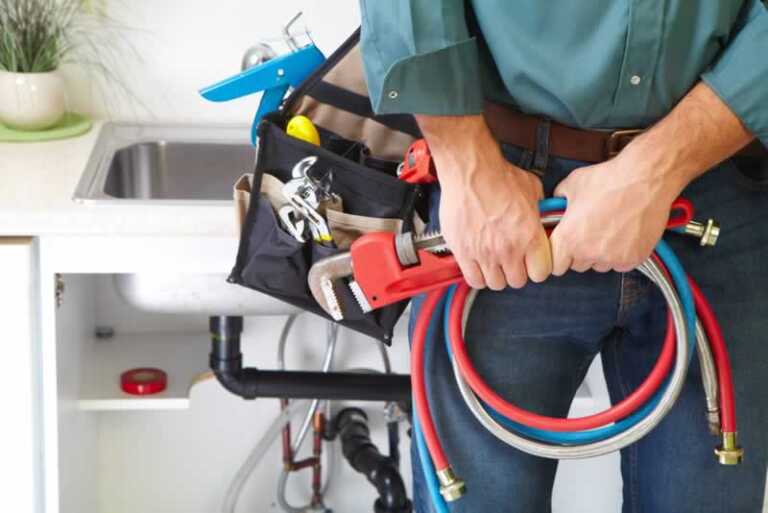 plumber with bag of plumbing tools