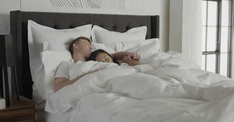 couple sleeping together in the bedroom