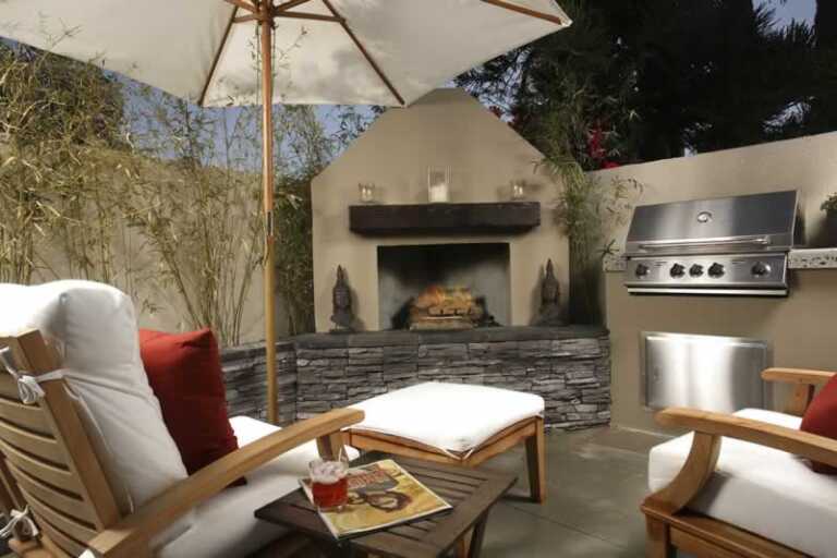backyard patio with fireplace and barbecue