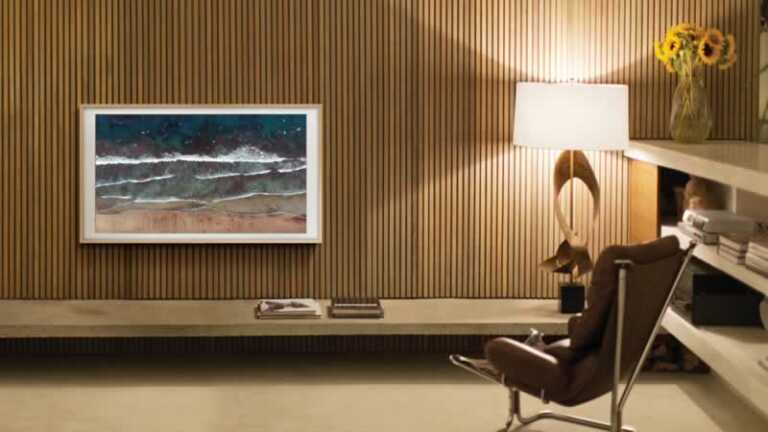 Samsung The Frame TV displaying a painting on wooden wall