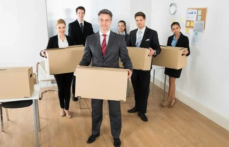 office team carrying moving boxes