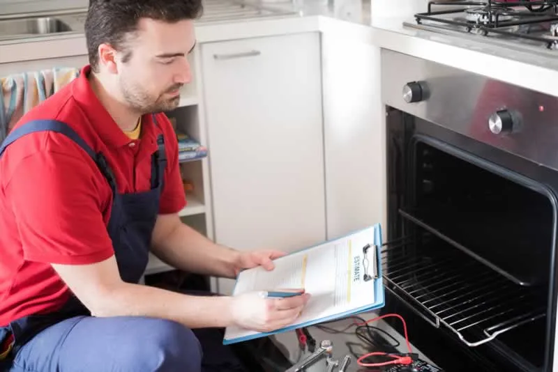 professional doing inspection of kitchen appliances