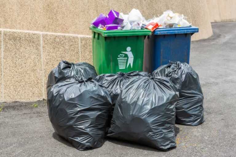 sorted household waste in bins and garbage bags