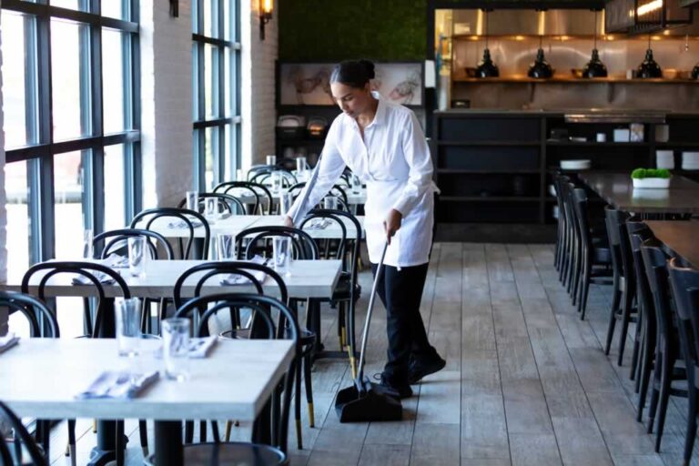 waiter cleaning the restaurant after closing