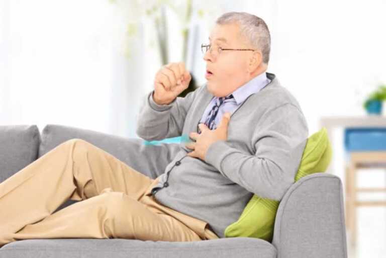 man coughing because of poor indoor air quality