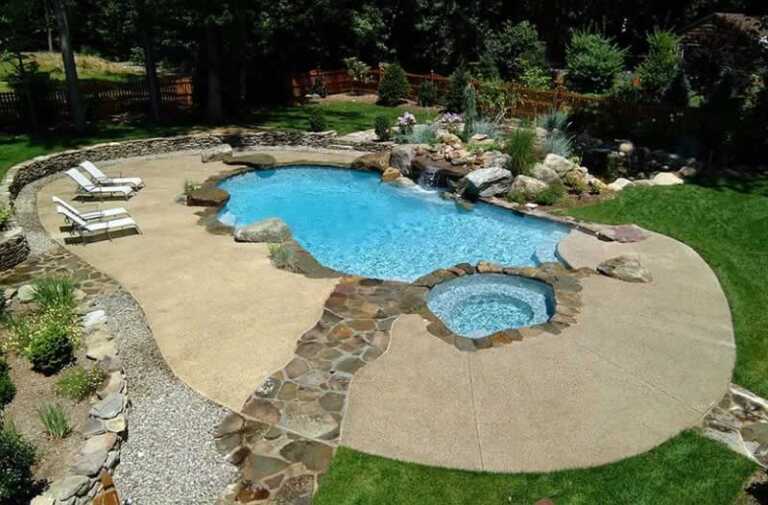 amazing pool with cement and rock decking