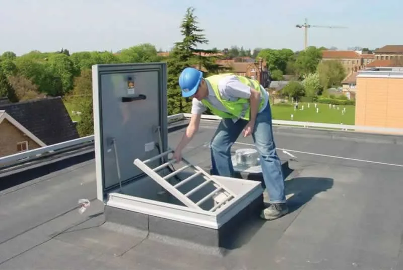 maintenance worker opening roof hatch