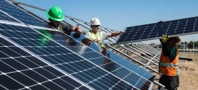 workers mounting solar panels