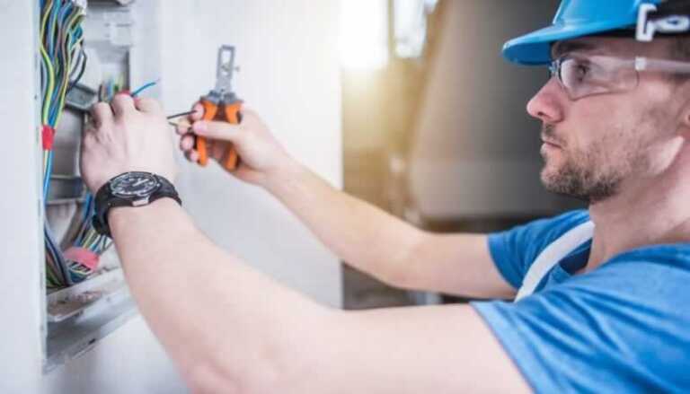 electrician rewiring the circuit breaker panel