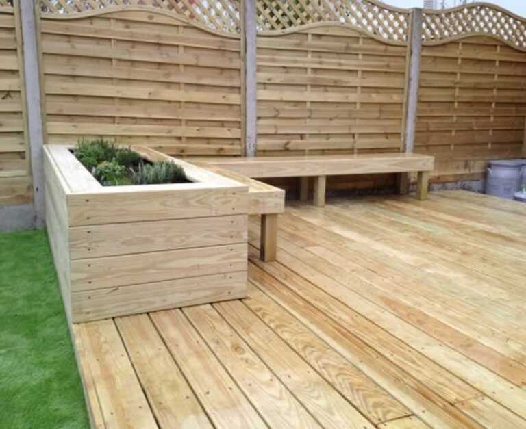 finished wooden DIY garden deck with bench and planter