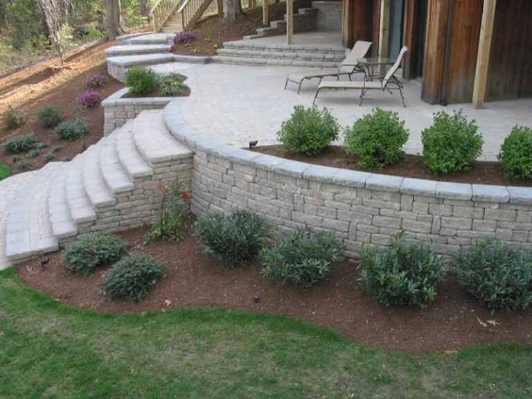 stone brick retaining wall with patio on top