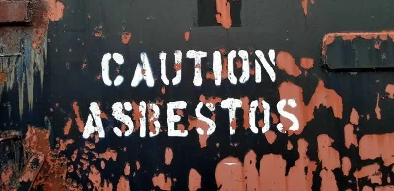 caution asbestos sign on the building