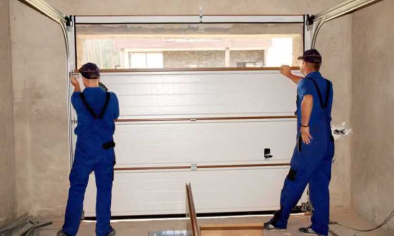 workers setting up new garage door