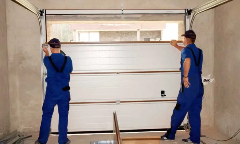 workers setting up new garage door