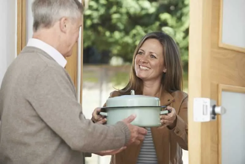 good neighbor giving cooked food