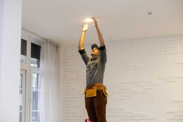 Man installing downlight