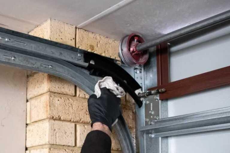 Cleaning garage door mechanism
