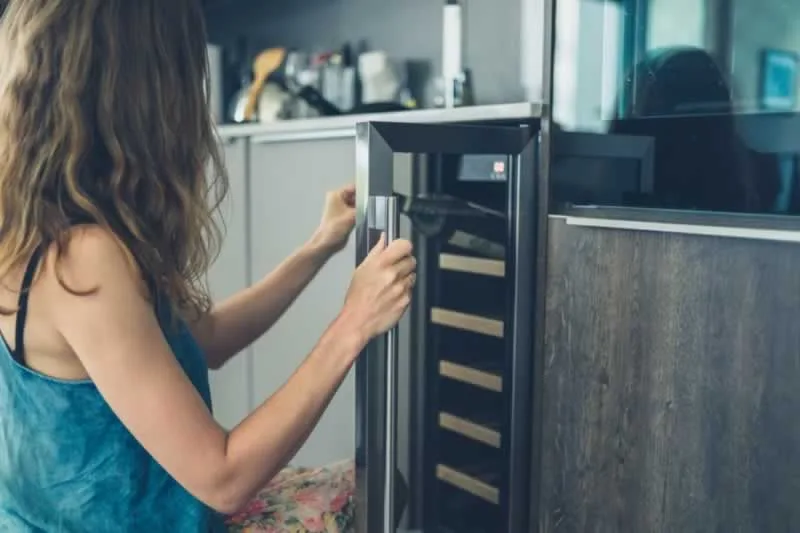 Woman testing wine cooler