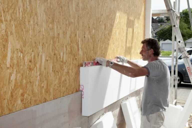 Man applying insulation board