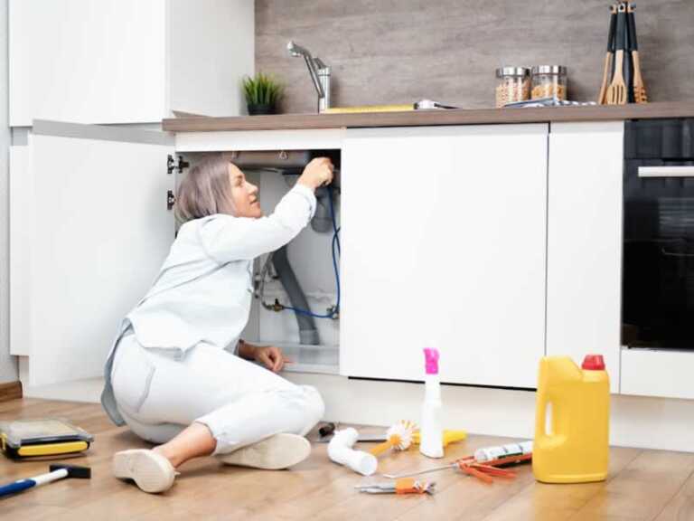 Women fixing the drain