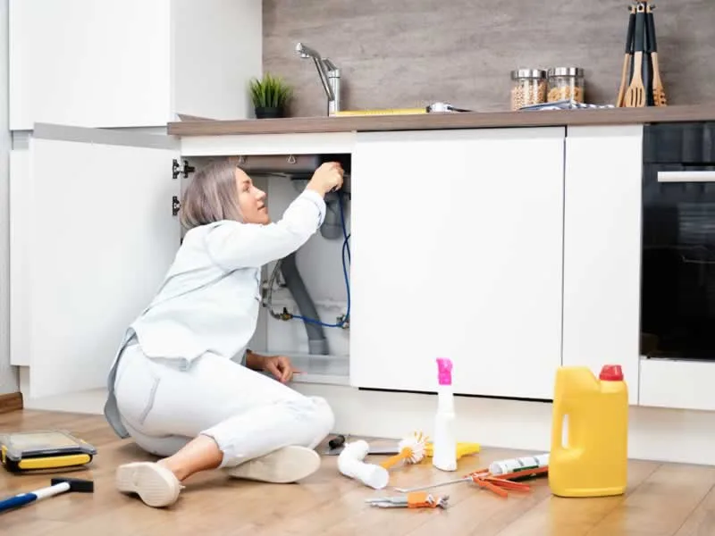 Women fixing the drain