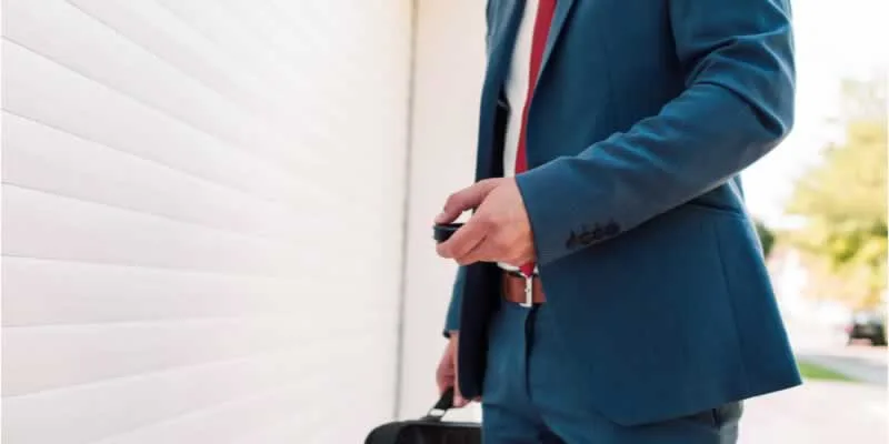 man with garage door remote