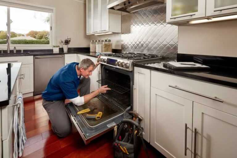 repairman fixing the oven