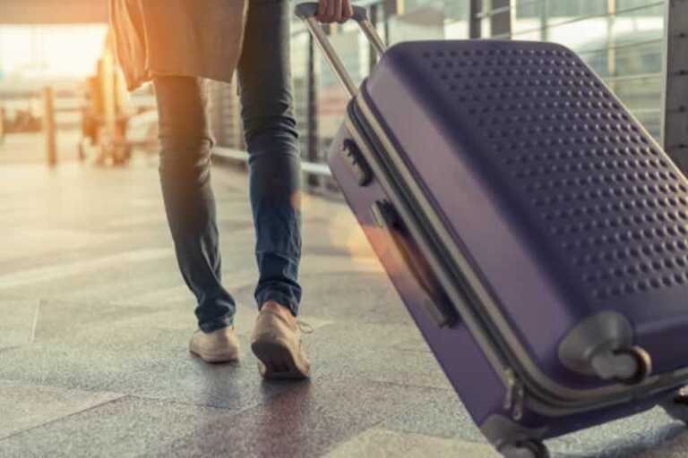 man pulling luggage