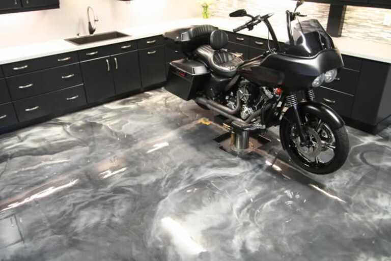 chopper on stand in the garage with epoxy flooring