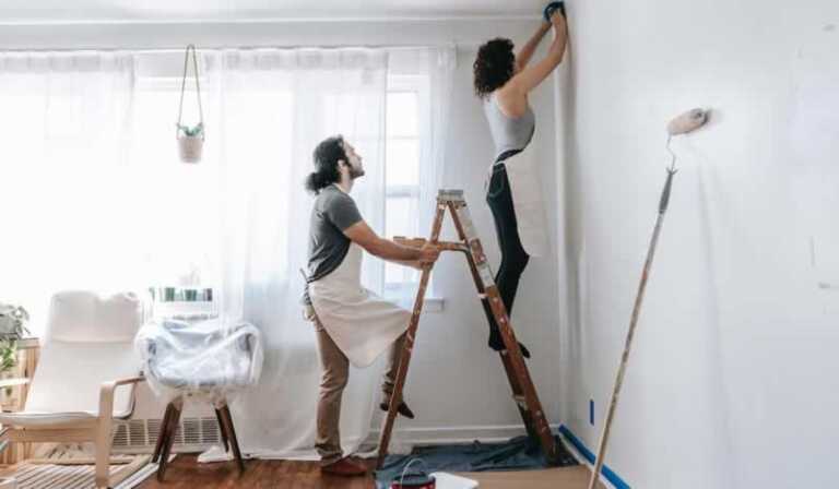 couple painting home interior