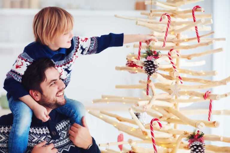 father and son decorating Christmas tree