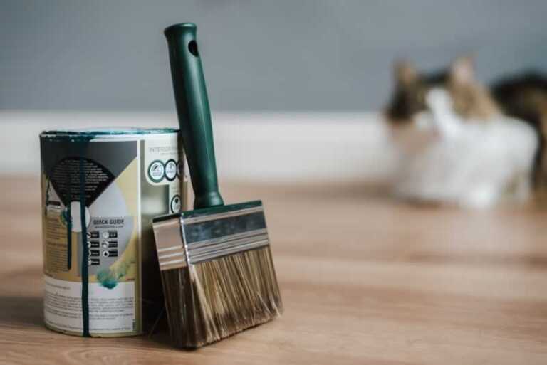 green paint and a paintbrush on the floor