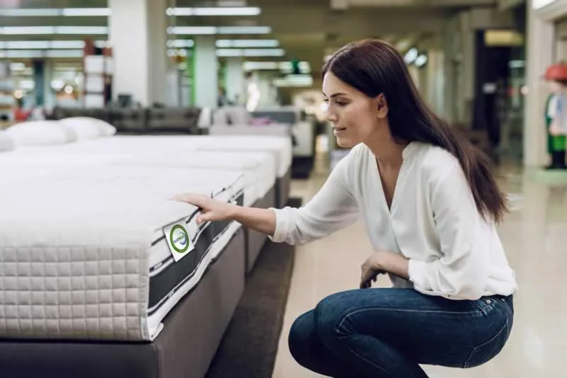 woman choosing mattress
