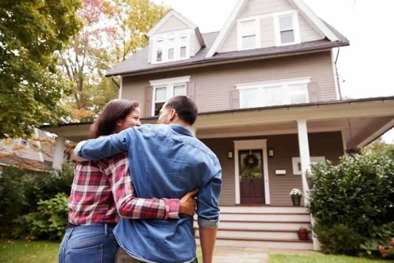 couple in front of new home