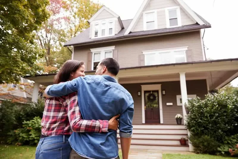 couple in front of new home