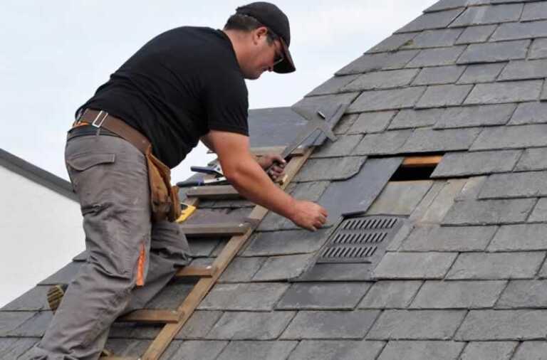 man repairing roof