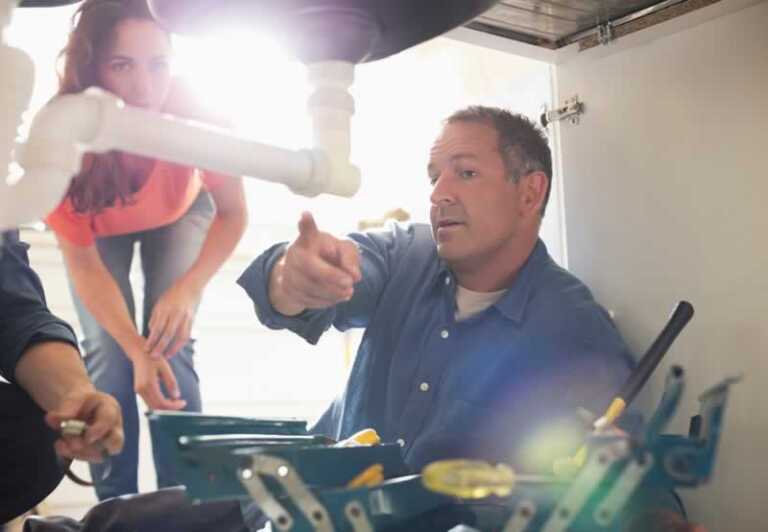plumber fixing sink drain