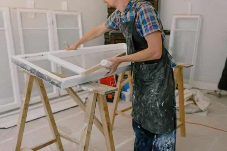 man restoring old window