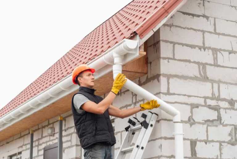 man installing downspout