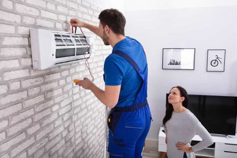 women with AC repairman