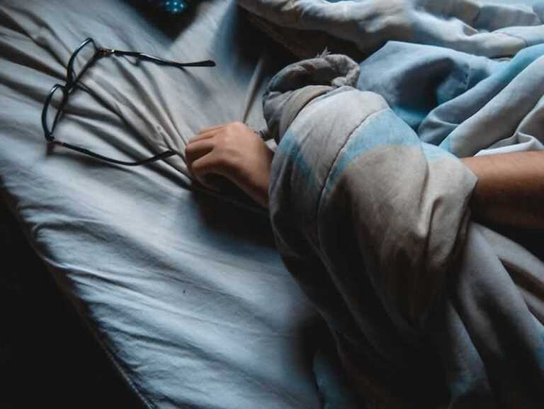 reaching for the glasses in bed