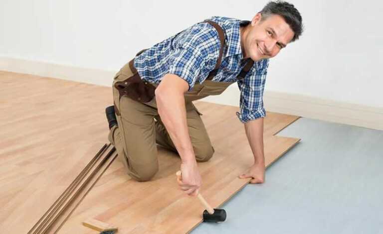 handyman laying flooring